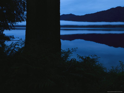 Twilight View with Mountains Casting Reflections into Calm Water