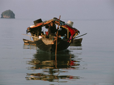 Buy Moken Tribesman Poles His Kabang Through Still Water Pulling a Canoe at AllPosters.com
