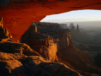 Breathtaking View Down the Canyon from a Warmly-Lit Mesa Arch
