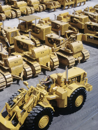 Rows of Brightly Colored Caterpillar Bulldozers Lined up at an Unidentified Factory
