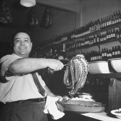 Cook in the Napoli Restaurant Holding up an Octopus, a Delicacy in Argentina