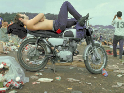 Shirtless Man in Levi Strauss Jeans Lying on Motorcycle Seat at Woodstock Music Festival