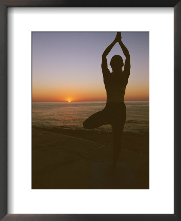 A woman doing yoga at sunrise on the East Cape of Baja, Mexico