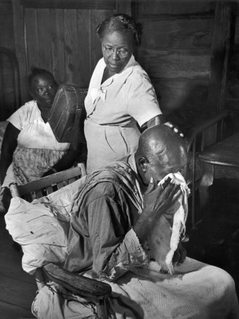 Nurse Midwife Maude Callen Tenderly Caring for an Old Chair-Bound Paralytic Touched by Her Kindness