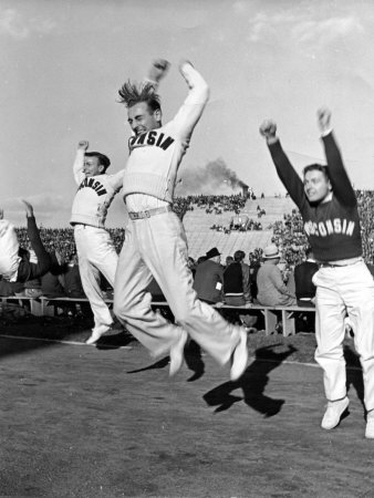 Male Cheerleaders in Action at Wisconsin-Marquette Football Game Poster