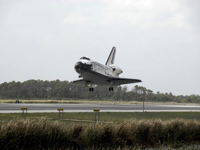 Space Shuttle Discovery Approaches Landing on the Runway at the Kennedy Space Center