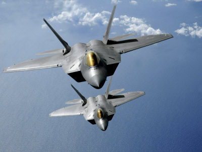 Two F-22 Raptors Fly over the Pacific Ocean