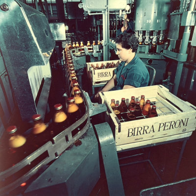 Peroni Factory, Worker Operating a Machine That Moves Bottles Full of Beer