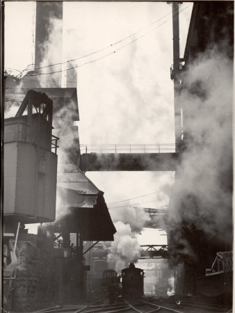 Steaming Hot Steel Slag Being Poured into Freight Cars on Railroad Siding at Steel Plant