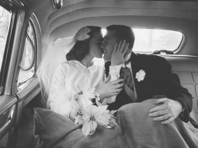 Mr. and Mrs. Thomas Beagan Jr. Kissing in Back of Car after their Wedding Ceremony