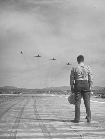 Officer Watching Military Jets Coming in for a Landing