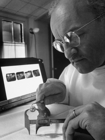 Dentist Dr. Harland Measuring Tooth to Be Used in Medical Dentistry