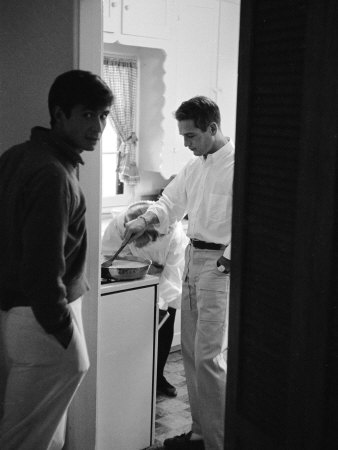 Actor Paul Newman Cooking Eggs for Guests Incl. Anthony Perkins During an Informal Party