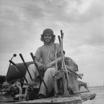 Man Working in the Oil Fields on a Large Piece of Equipment