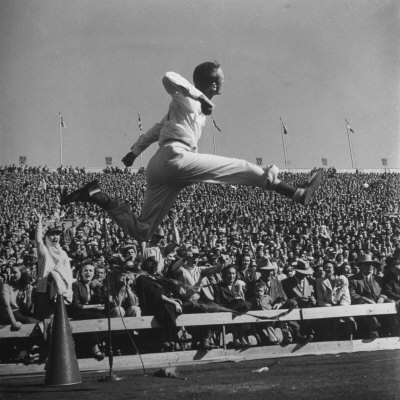 Smu Cheerleader Leaping High into Air at University of Texas Football Game Poster