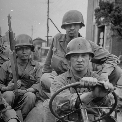 US and Korean Soldiers Riding in a Jeep