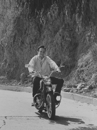 Country Singer Roger Miller Riding a Motorcycle