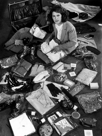 Life Photographer Margret Bourke-White Sitting Amidst Contents of Opened Suitcase