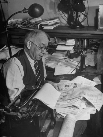 Wilbur Sutton, Editor of the Press Newspaper, Working at Desk in His Office
