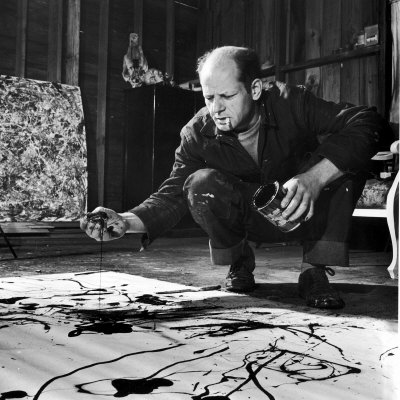 Painter Jackson Pollock Working in His Studio, Cigarette in Mouth, Dropping Paint onto Canvas