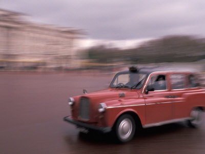 Cab racing past Buckingham Palace, London, England