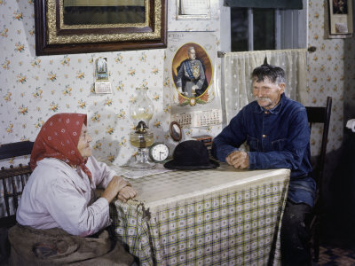 Portrait of Elderly Farming Couple Sitting at a Kitchen Table