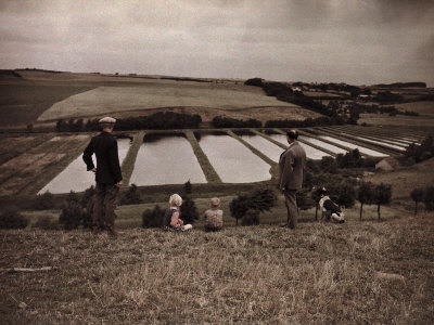 Visitors Look Down on Fish Hatcheries across Landscape Along Railway