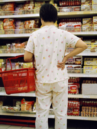 Chinese Woman Contemplates Food Selections at a Grocery Store