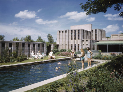 People Sunbathe and Swim in a Pool at a Tulsa Editor