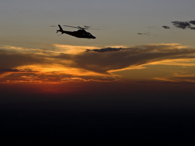 Helicopter Silhouetted Against a Dramatic Sky at Sunset