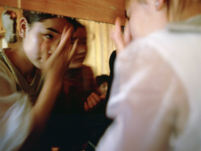 Mongolian Performer Puts Makeup on Backstage before a Performance