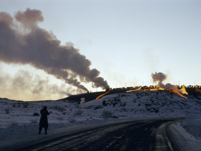 Buy Silhouetted Figure Walks Road Below Hillside Where Molten Slag Flows at AllPosters.com