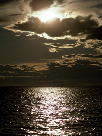 Setting Sun Pierces a Menacing Storm Front over the Atlantic
