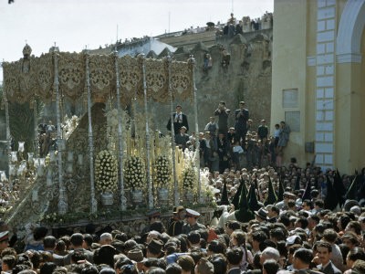 Crowds Watch as Penitents Follow Procession of Statue of Virgin Mary