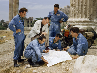 International Travelers Gathered in Ancient Temple Ruins Study a Map