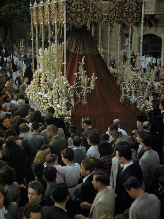 Praying Crowds Follow a Statue of Virgin Mary on a Dais