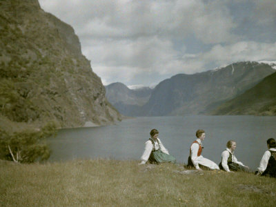 Norwegian Women in Traditional Dress Relaxing in a Scenic Fjordland