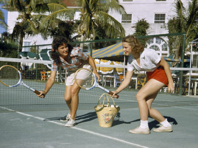 Female Tennis Pro and a Student Practice Swings on a Tennis Court