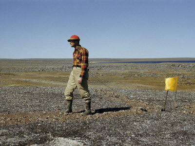 Scientist Drags a Magnet across Tundra to Pick Up Ore Particles