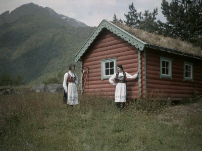 Wooden House and Two Norwegian Women in Traditional Dress