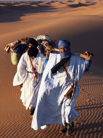 Berber Tribesmen Lead their Camels Through the Sand Dunes of the Erg Chegaga, in the Sahara Region