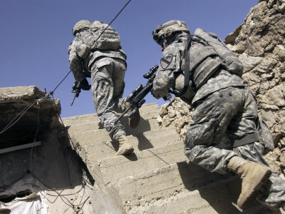 Soldiers Running Up Staircase of a Building During a Mission in Mosul, Iraq