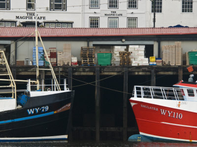 Fishing Boats in Whitby Harbour with Famous Magpie Cafe in Background, Yorkshire, England