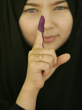 Young Girl Shows Her Inked Finger, Even Though She Was Too Young to Vote, in Karbala, Iraq