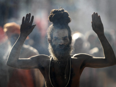 Naked Hindu Holy Man Performs Rituals on Banks of River Ganges During the Kumbh Mela in India