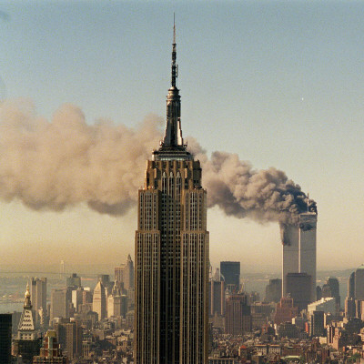 Twin Towers of the World Trade Center Burn Behind the Empire State Buildiing, September 11, 2001