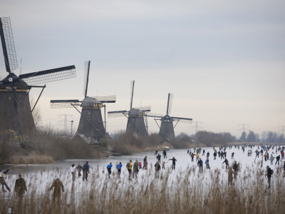 Buy People Skate on Frozen Canals in Kinderdijk's Mill Area, a UNESCO World Heritage Site, Netherlands at AllPosters.com