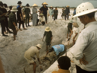 Workers Unearth Mass Grave Containing Victims of a Vietcong Massacre from the Tet Offensive