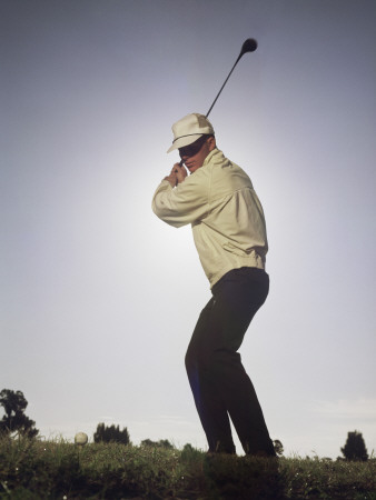 Young Golfer About to Hit Golf Ball on Tee Poster
