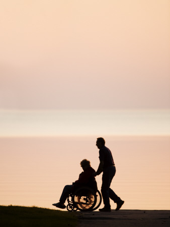 Man Pushing His Senior Mother in a Wheelchair Near Seashore, Motala, Sweden